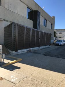 A PalmSHIELD brown louvered fence installed on the side of a Los Angeles building