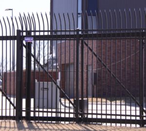 An automatic ornamental cantilever gate featuring a gate operator and key pad
