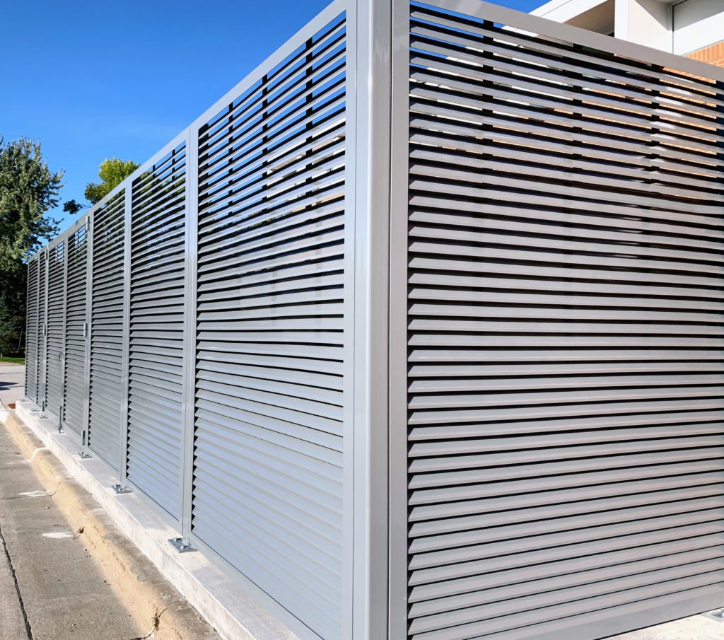PalmSHIELD Louvers. Steel vertical louver screen system.  architectural mechanical screening screen louvered semi private private solid staggered board on board shadow box alternating ametco barnett and bates industrial louvers rooftop louvers beta orsogrill omega chillers generators truck wells outside storage condensors rooftop equipment patios trash dumpsters transformers HVAC courtyards pool equipment fence aluminum galvanized steel degree of openness direct visibility standalone wall louvers 