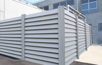 Gray vinyl economic louvered screening enclosure for commercial HVAC.