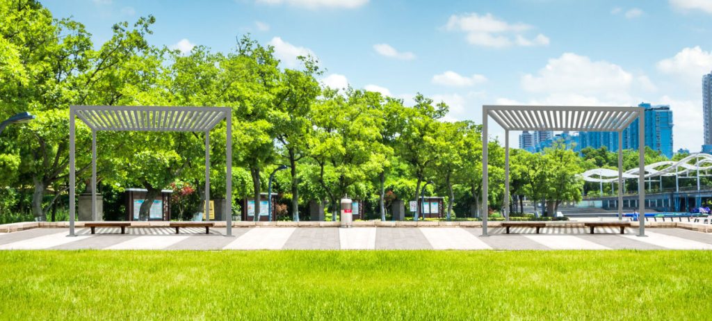 Two sun shade structures in public park setting.