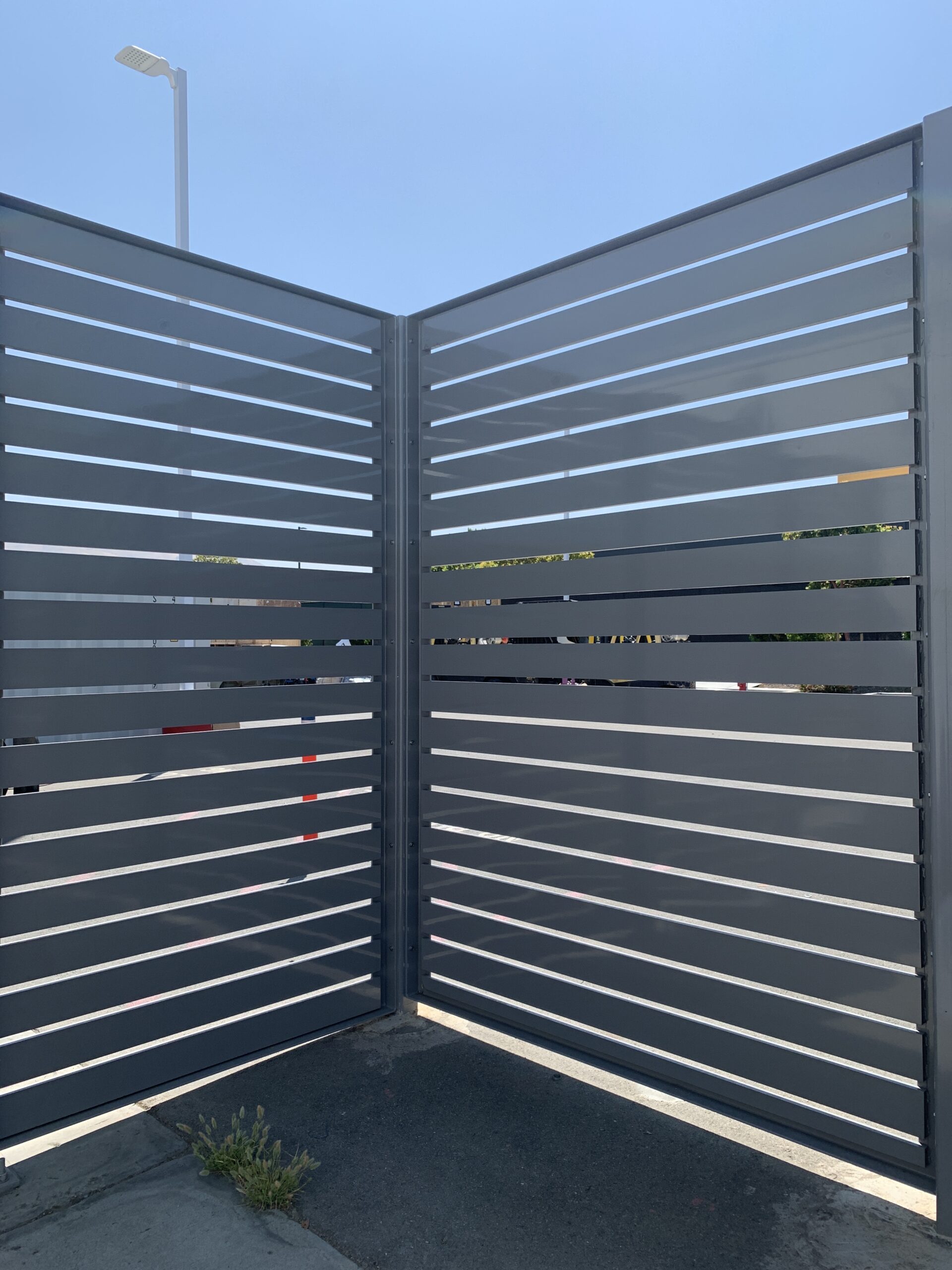 An inside view of semi-private screening enclosure, with a work zone visible between the louvers.