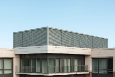 An Indiana condominium complex with a louvered rooftop screen system installed above its top floor.